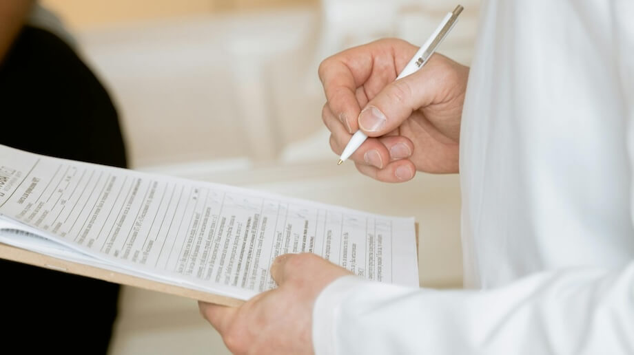 Doctor in White Coat With Clipboard - Lab Testing